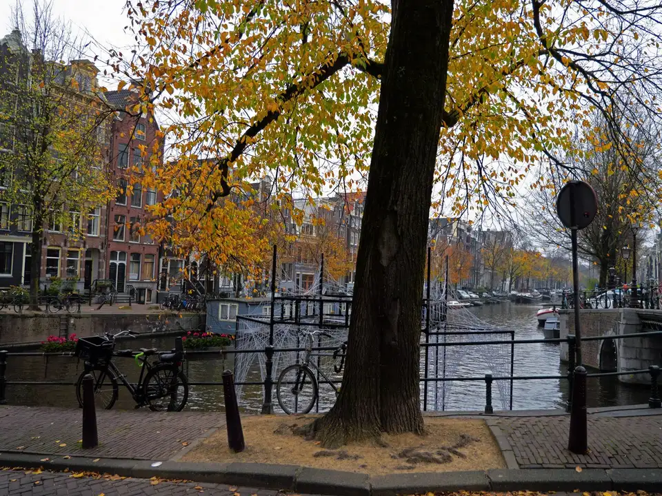 The start of the Herengracht in Amsterdam in autumn, bicycles along the railing